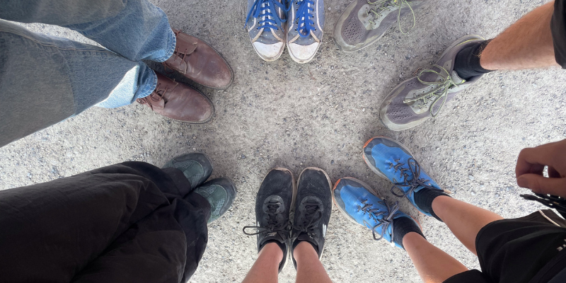 A group of people's feet pointing together, viewed from above